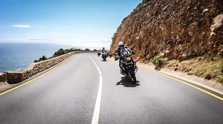 BMW motorbikes for rent riding on a road in Cyprus